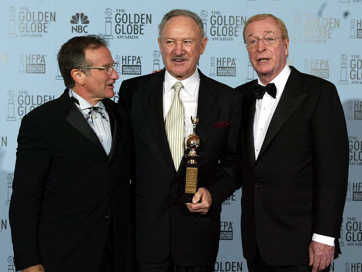 Gene Hackman acompañado por los actores Robin Williams y Michael Caine. (AFP)